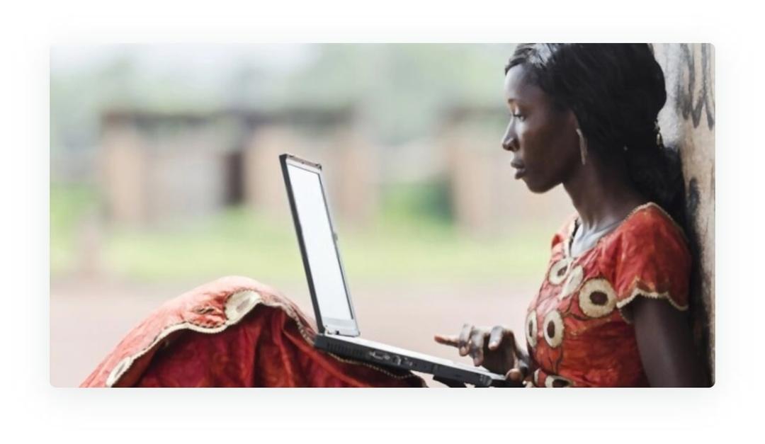 african woman holding laptop